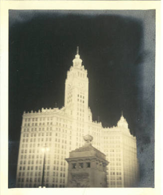 Nighttime photograph of the Wrigley Building and Fort Dearborn Monument in downtown Chicago