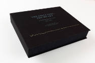Cover of black portfolio box with turquoise text reading “THE FIRST TIME, THE HEART…” and wavy line