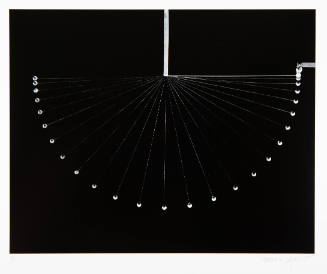 Black and white, stop-motion photograph of pendulum swinging and forming a semi-circle 
