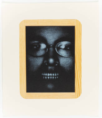 Close-up of a person wearing glasses and baring teeth, surrounded by an illusionistic wooden frame