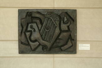Rectangular relief with intersecting geometric lines and circular divots 