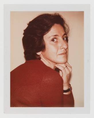 Over-the-shoulder polaroid of a light-skinned woman in a red sweater with her hand under her chin