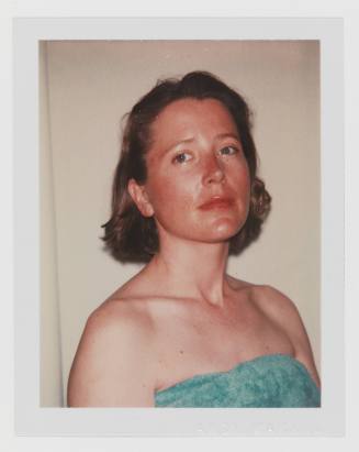 Polaroid of fair-skinned woman with blonde hair looking at camera in strapless shirt or towel