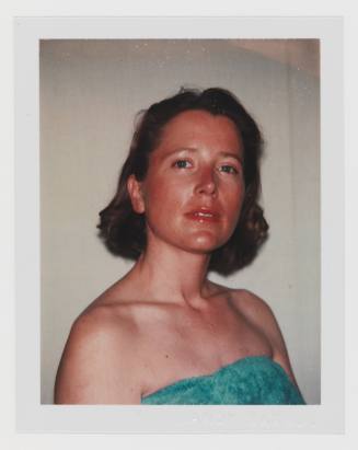 Polaroid portrait of light-skinned woman with dark blonde, bobbed hair in strapless turquoise shirt