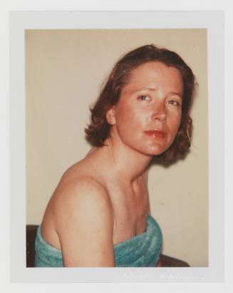 Polaroid portrait of light-skinned woman with dark blonde, bobbed hair in strapless turquoise shirt