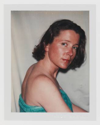 Polaroid portrait of light-skinned woman with dark blonde hair looking over shoulder toward camera