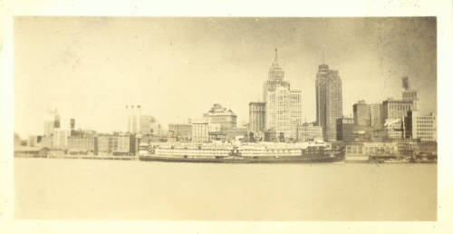 Snapshot of city skyline with boats, seen from a body of water