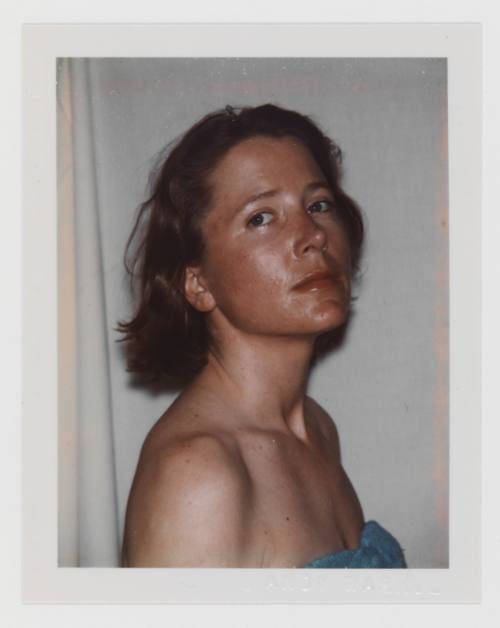 Polaroid portrait of light-skinned woman with dark blonde, bobbed hair in strapless turquoise shirt