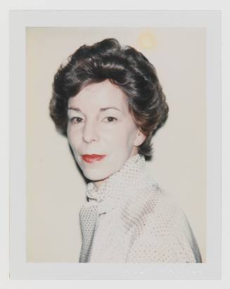 Polaroid portrait of woman with short, upswept hair, white cakey makeup, lipstick, and dotted blouse
