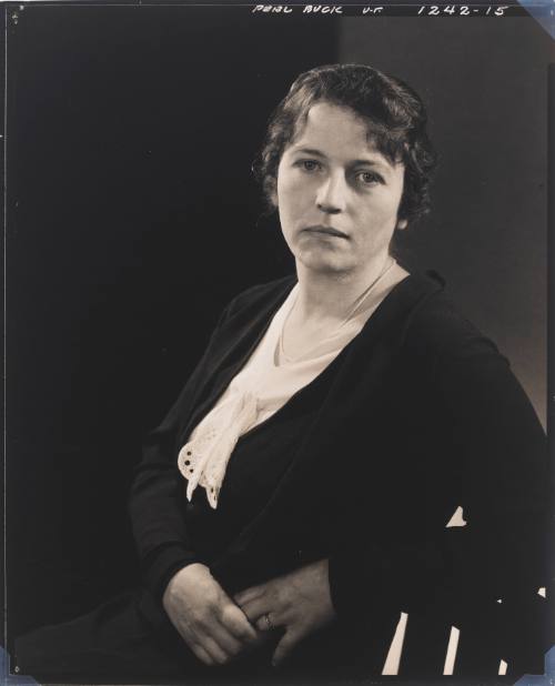Photograph portrait of Pearl S. Buck, from waist up, seated in chair and wearing blouse with jacket