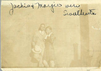 Young couple in dress clothes and handwritten text “Jackie & Margie were sweethearts”