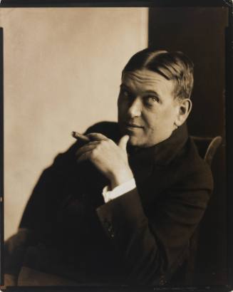 Portrait of H.L. Mencken, a man with light skin tone and dark hair, seated and holding a cigar