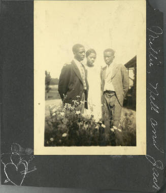 Photograph mounted on black paper: three young people with dark skin tone wearing formal clothes