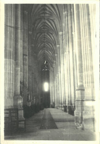 Black-and-white photograph of the interior aisle of a Gothic church