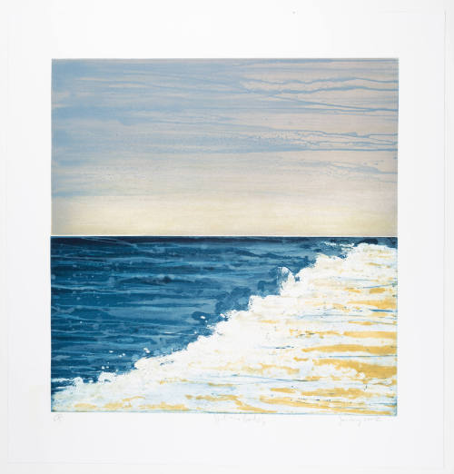 Seascape in blues and yellows with the ocean extending from the left and white foam and sand on righ