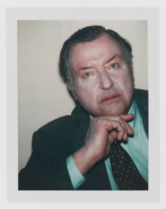 Polaroid of man with graying hair and medium-light skin tone with cakey make-up in suit and tie