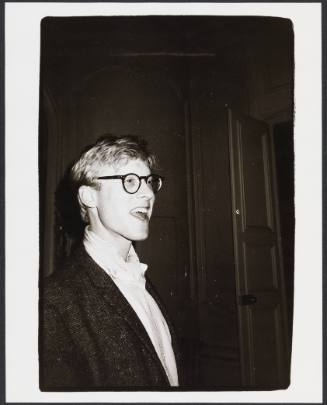 Black-and-white photo of man with rounded glasses looking off to the right with surprised expression
