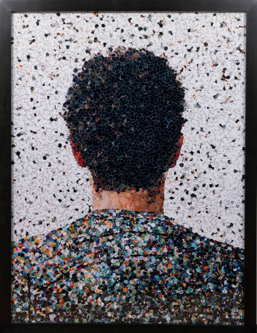 Photograph of collage of back of short-haired person's head made from magazine scraps.