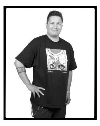 Portrait of man smiling, hand on hip, wearing shirt with design of a Native American on motorcycle