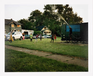 Shea Cobb, Amber Hasan, and Her Children, Nieces, and Nephews (Zari, DJ, Jayda, Justin, Justace, Jaylen) and Their Friends Playing in the Water Moses West Is Spraying from His Atmospheric Water Generator on North Saginaw Street Between East Marengo Avenue and East Pulaski Avenue, Flint, Michigan, from the series Flint Is Family