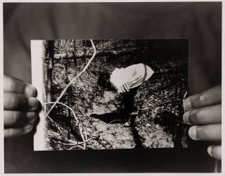 Zion Holding a Picture of Her Mother Shea Sipping Water from Her Freshwater Spring at Age Thirteen in 1997, Jasper County, Newton, Mississippi, from the series Flint Is Family