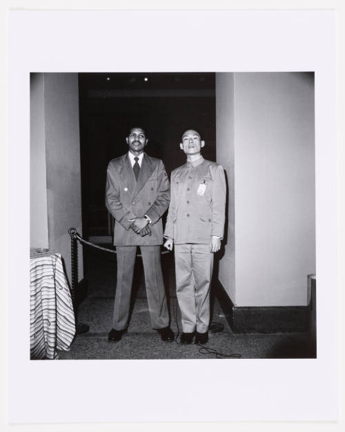 Black-and-white photograph of two men, one wearing a suit and tie and the other wearing a Mao suit