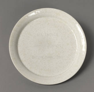 Plate with white and grey marbled glaze, faint text reads "ALL THINGS ARE DELICATELY INTERCONNECTED"