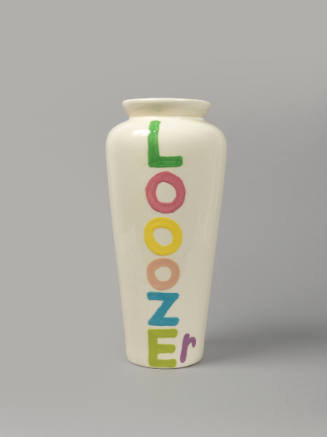 White, urn-shaped vase with the rainbow letters spelling “LOOZEr” written vertically down its body