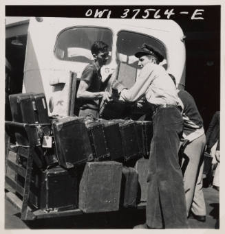 Loading baggage on a Greyhound bus at the bus terminal.  Cincinnati, Ohio