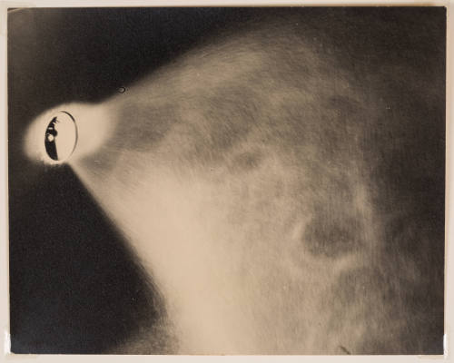 Sepia-toned print of a highlighted ellipse on left spraying cloud of mist against black background