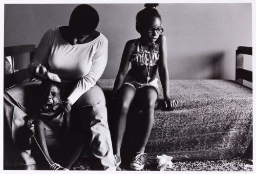 Combing hair, Amoke Alayoe and her children, Silver Spring, Maryland, June 1978
