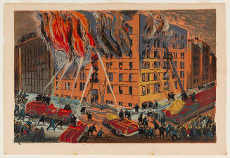 Firemen and crowd gather around a multi-unit building on the corner that is engulfed in flames 