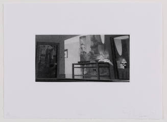Dimly lit interior with image of two men on door and image of woman in lingerie on right wall